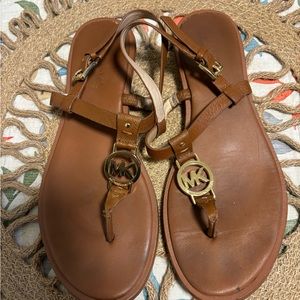 MK Sandals brown in color.